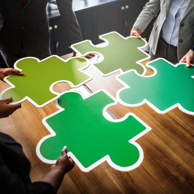 business-people-connecting-puzzle-pieces 1